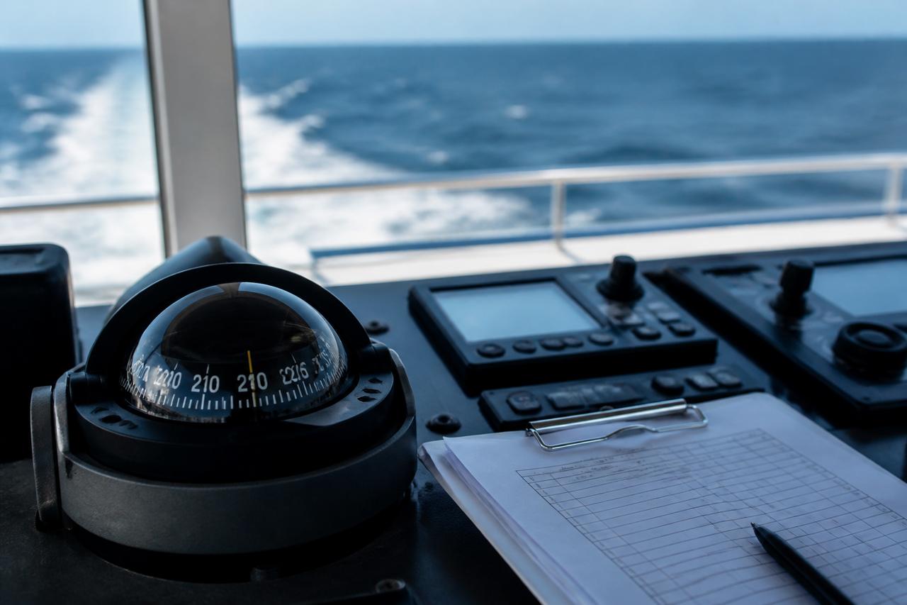Marine instruments and sea-trial checklist with ocean wake beyond