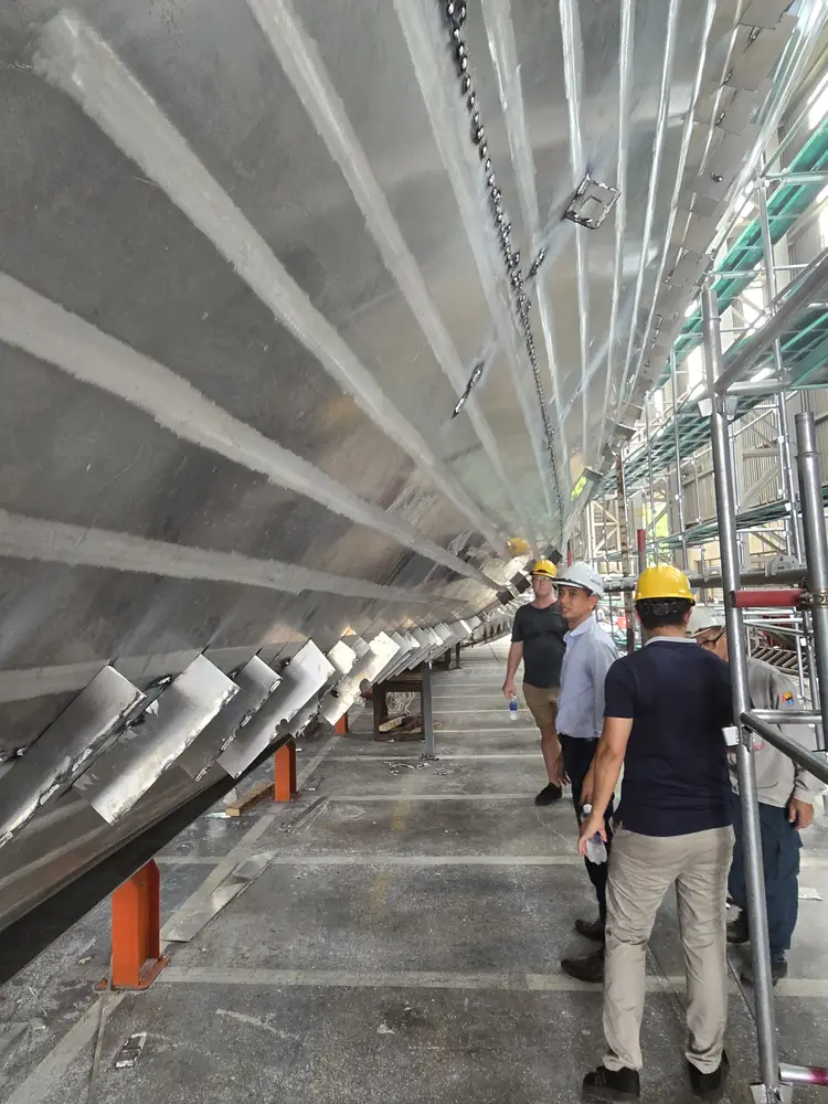 Portrait-oriented walkthrough inside unfinished aluminum hull